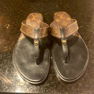 Louis Vuitton sandals.